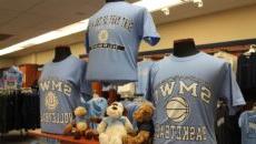 A SMWC basketball shirt, a SMWC volleyball shirt and several stuffed animals on display in the bookstore.